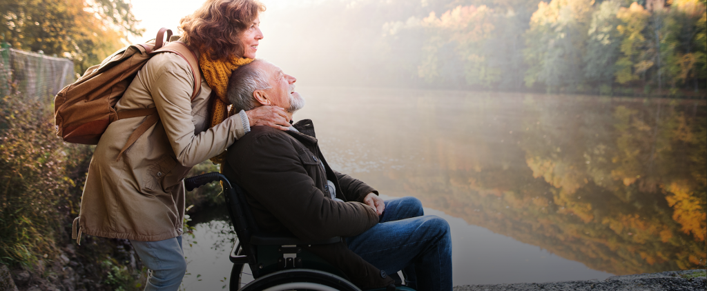 senior-couple-with-wheelchair-in-autumn-nature-5WHMCX8 copy